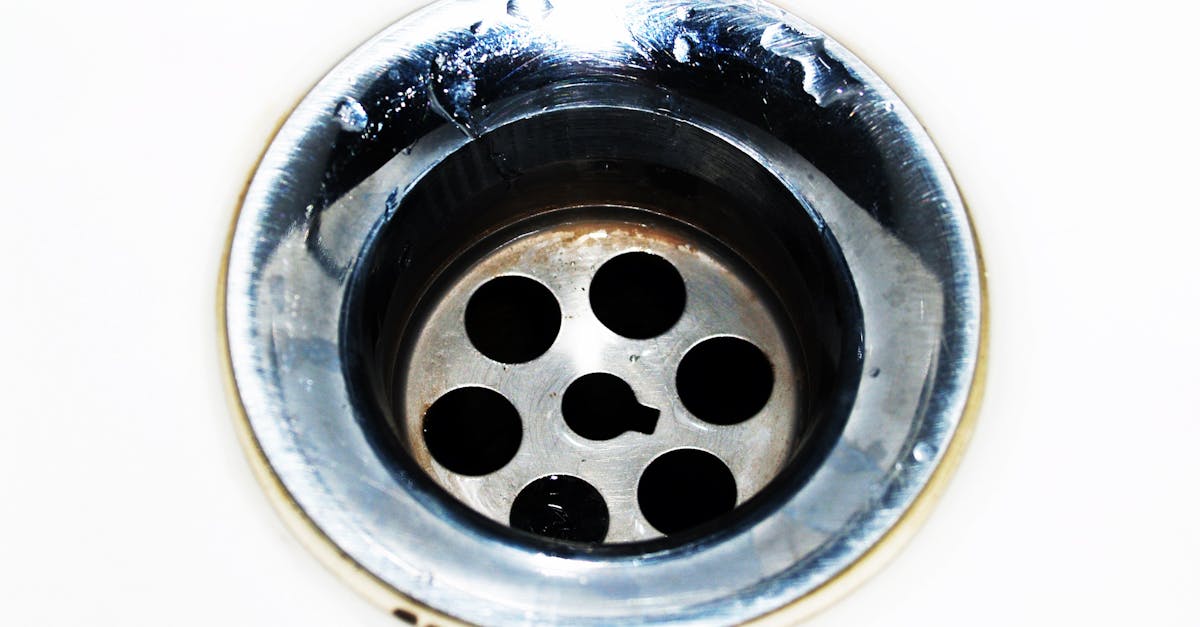 Plumber performing drain cleaning with professional tools